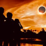 Mother with children watching solar eclipse